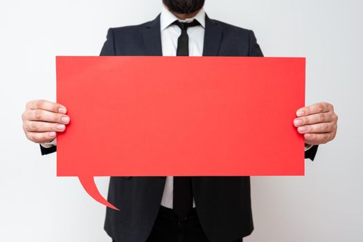 Businessman Holding Speech Bubble With Important Informations.