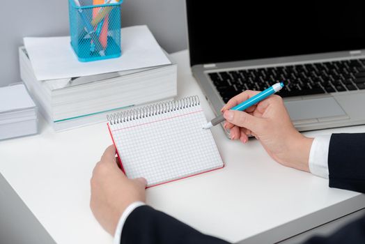 Businesswoman Holding Pen And Note With Important Message With One Hand.