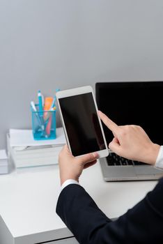 Businesswoman Holding Tablet And Pointing With One Finger On Important News