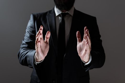 Businessman In Suit Holding Important Informations Between Hands.