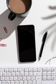 Phone Screen With Important Message On Desk With Keyboard, Pen And Coffee.