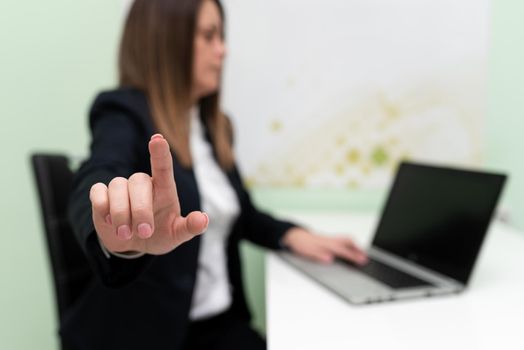 Woman Typing Updates On Lap Top And Pointing New Ideas With Pen.