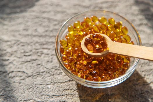 Vitamin D from fish oil capsules. Selective focus medical