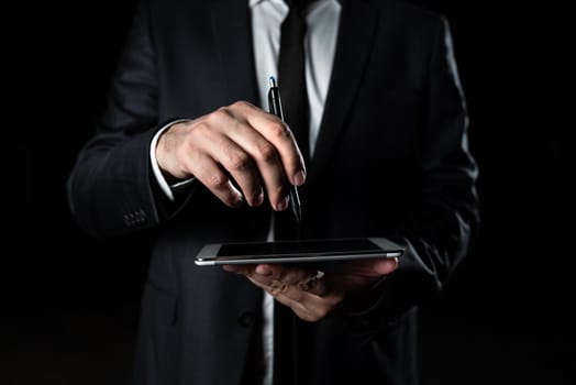 Businessman Holding Tablet And Pointing Important Message With Pen.