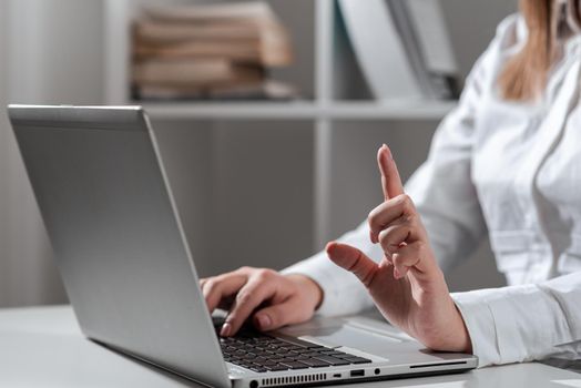 Woman Typing Updates On Lap Top And Pointing New Ideas With One Finger.