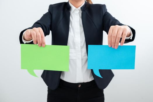 Businesswoman Holding Two Speech Bubbles With Important Messages.