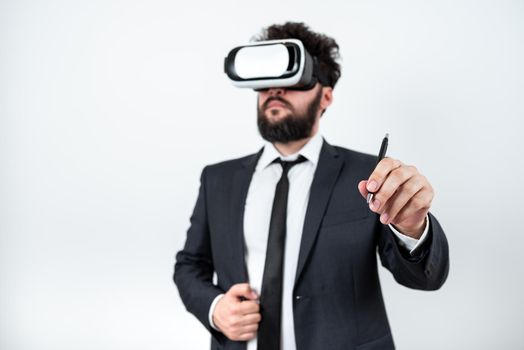 Man Wearing Vr Glasses And Pointing On Recent Updates With Pen.