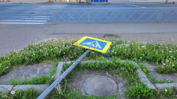 Repair installation of a road sign pedestrian crossing.