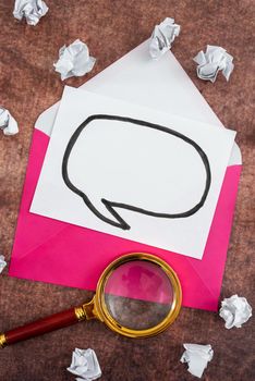 Speech Bubble Letter With Envelope And Magnifying Glass Over Wood.