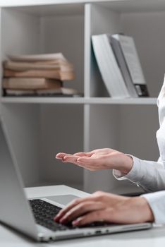 Woman Typing Recent Update On Lap Top And Holding Important Ideas Over Hand