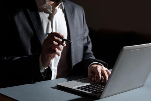 Man Typing Important Data Into Laptop And Pointing New Idea With Pen.