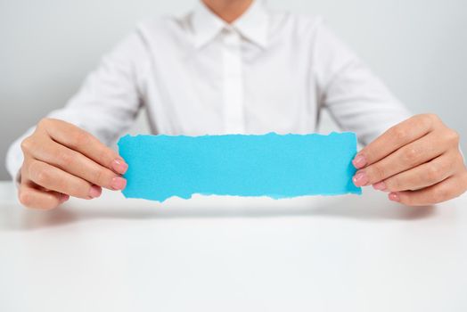 Businesswoman Holding Note With Important Message On Office Desk.