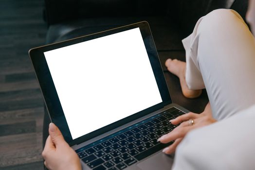 Woman working behind a laptop.Over the shoulder close-up screen mockup.Business woman working from home.Copyspace mockup Computer laptop Notebook concept