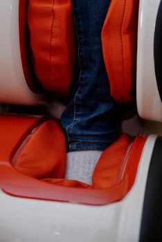 Woman relaxing in massage armchair.Closeup of legs of a woman relaxing on the electric massage chair