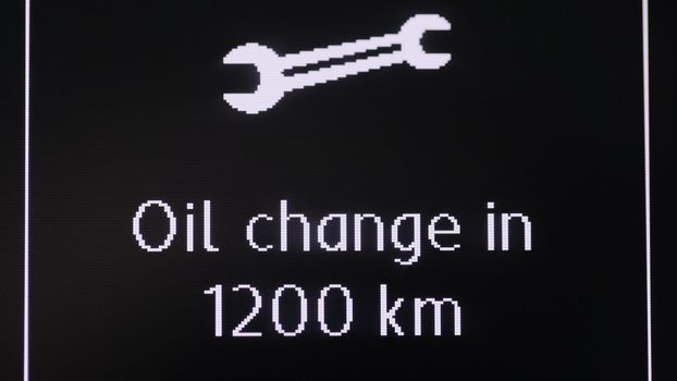 Icon service for replacement of oil fluids of the car. Car dashboard with oil change sign.