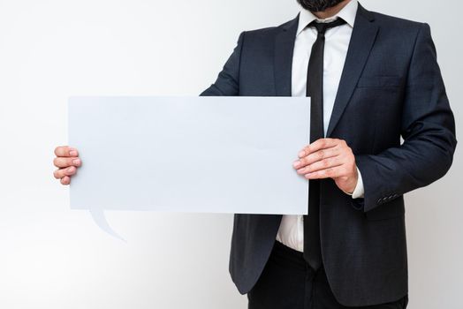 Businessman Holding Speech Bubble With Important Informations.