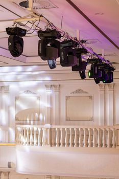 Light system of various light heads hung on the farm under the ceiling in the event hall, vertical, copy space. Almaty, Kazakhstan - November 06, 2021