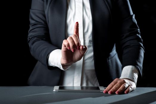 Businesswoman Having Tablet On Desk And Pointing New Ideas With One Finger.