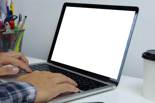 Hand man using keyboard computer laptop mock up blank white screen monitor technology online internet digital advertising business concept.