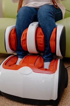 Woman relaxing in massage armchair.Closeup of legs of a woman relaxing on the electric massage chair