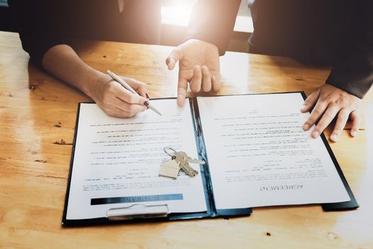 estate agent gives pen and documents agreement with customer to sign contract. Concept agreement