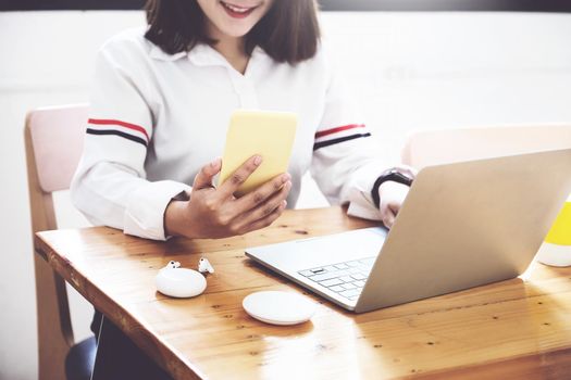 freelance concept,female using smartphone and computers to design work as ordered by customers