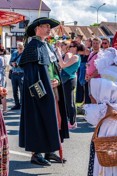 Straznice, Czech Republic - June 25, 2022 International Folklore Festival. A man in a festive folk coat, with a hat