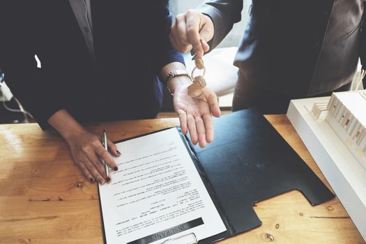 estate agent gives pen and documents agreement with customer to sign contract. Concept agreement