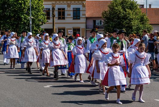 Straznice, Czech Republic - June 25, 2022 International Folklore Festival Boys and girls in colorful folk costumes in the procession