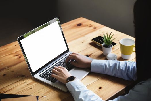 freelance concept, woman using computers laptop on wooden desk blur background. Laptop computer with blank screen and can be add your texts or others on screen