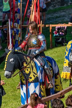 WYWAR CASTLE FEST, demonstrations of knightly fights A knight on horseback with a spear waits for an opponent in a tournament