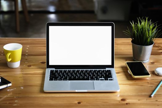 Close-Up laptop on wooden desk blur background. Laptop computer with blank screen and can be add your texts or others on Laptop