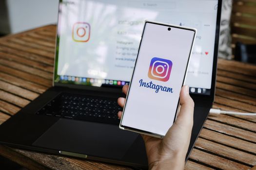 CHIANGMAI, THAILAND - July 09, 2021: A woman holding smartphone with Instagram application on the screen. Instagram is a photo sharing app for smartphones