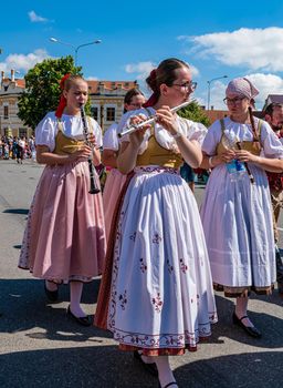 Straznice, Czech Republic - June 25, 2022 International Folklore Festival. Beautiful girls in folk costumes play at the festival