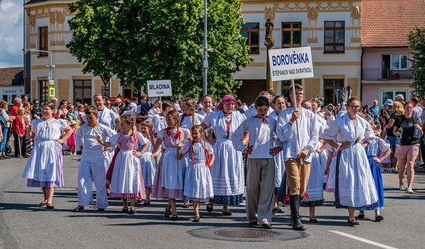 Straznice, Czech Republic - June 25, 2022 International Folklore Festival. Boys and girls in a procession in folk costumes from Moravia