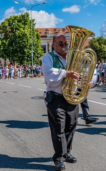 Straznice, Czech Republic - June 25, 2022 International Folklore Festival. A man with a bass flugelhorn in a folk costume