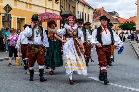 Straznice, Czech Republic - June 23, 2022 International Folklore Festival Men and women in folk costumes on the streets of the city