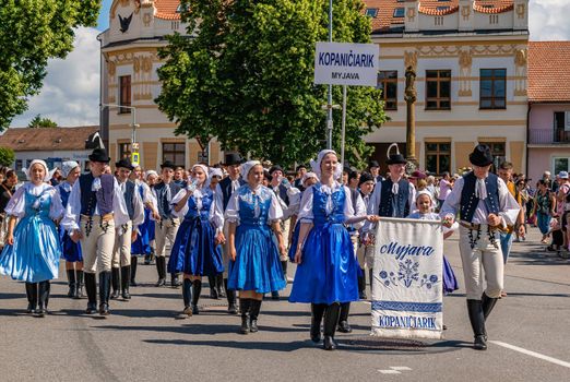 Straznice, Czech Republic - June 25, 2022 International Folklore Festival. People in Slovak folk costumes in a procession