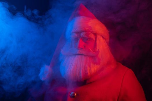 Santa claus in blue red smoke. Party for Christmas