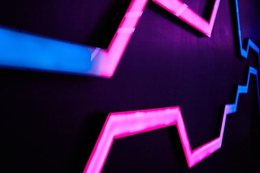 Image of Abstract neon blue and pink lights on wall pattern