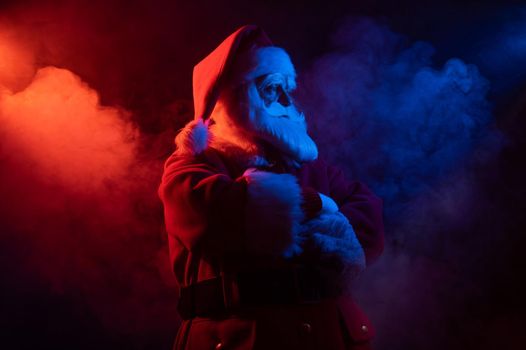 Santa claus in blue red smoke. Party for Christmas