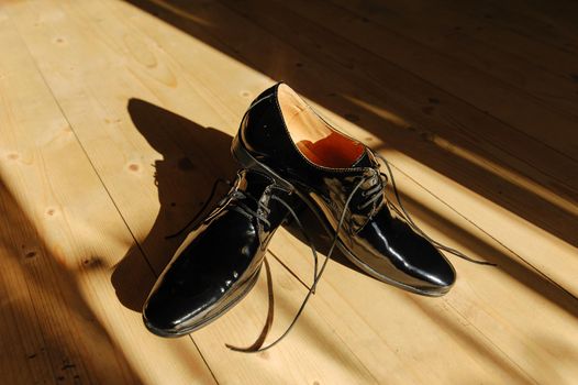 Black men's shoes in bright sunshine