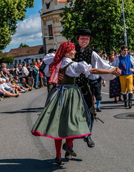 Straznice, Czech Republic - June 25, 2022 International Folklore Festival. A man and a woman in folk costume dance at the festival