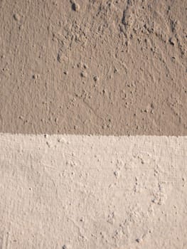 Close-up on a wall made of two-tone plaster. Double color wall ..