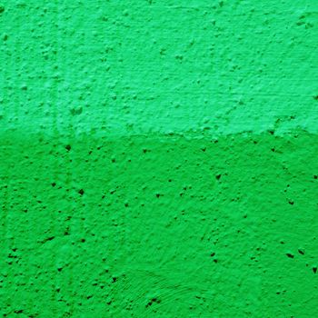 Two color cement wall texture. The concrete wall is divided into two pieces of different green paint.