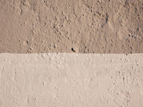 Close-up on a wall made of two-tone plaster. Double color wall .