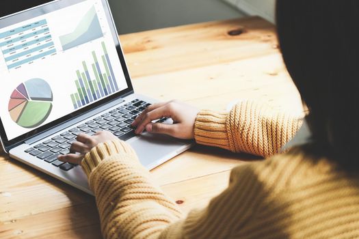 A female employee using computer to check the company's investment budget