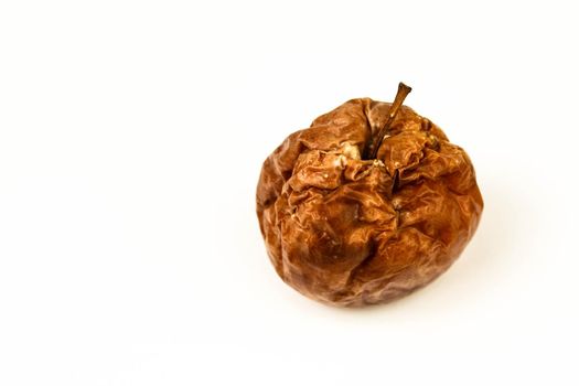 Old rotten apple with large DOF on white background.