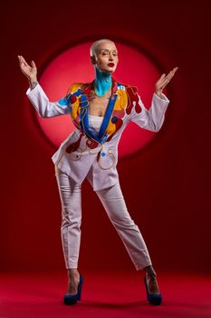 Behold the Queen of the palace. Studio shot of a stylish young woman posing against a red background