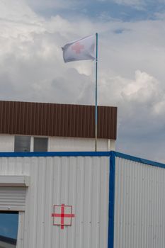 RUSSIA, MOSCOW - JUN 26, 2022: Flag flying square switzerland cross swiss red embassy usa medical, for postage institution from international from morning mark, sign printing. Office george,